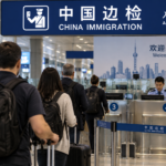 International travelers with luggage queue at China Immigration arrival inspection counters at a Chinese airport.